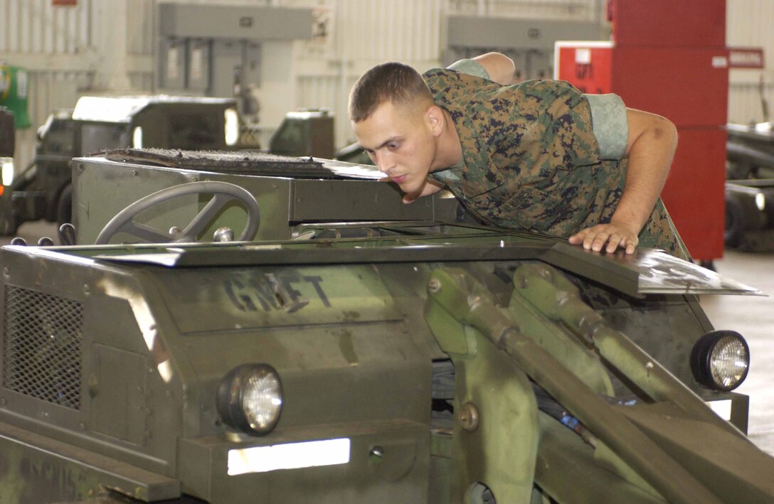 AL QAIM, Iraq ? Captain Brian J. Madora, an AH-1W Super Cobra pilot with Marine Light/Attack Helicopter Squadron 269, Detachment Al Qaim looks over some of the ordnance that will be loaded on his helicopter before flying out on a mission during Operation Spear on June 17.  Madora, from Montclair, Va., is one of the most knowledgeable pilots in the squadron.  He is on his third deployment in support of Operation Iraqi Freedom.