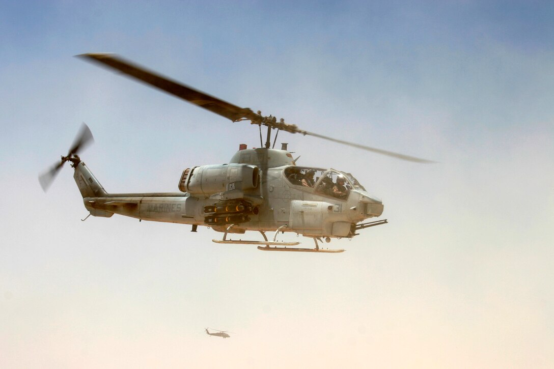 AL QAIM, Iraq - An AH-1W Super Cobra from Marine Light/Attack Helicopter Squadron 269, Detachment Al Qaim flies off to escort a UH-60A Blackhawk during a medical evacuation mission June 17.  The 'Gunrunners' recently supported Operation Spear, an offensive aimed at eliminating insurgents and foreign fighters from the northwestern Al Anbar province.