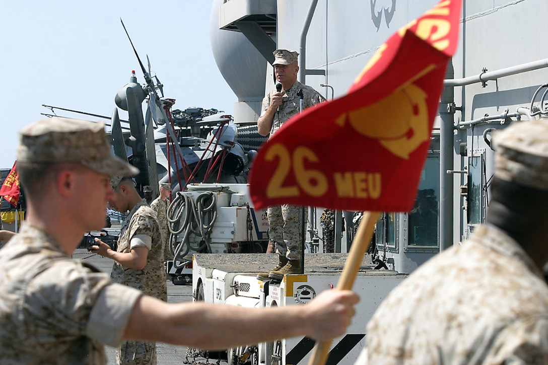 General Michael W. Hagee, commandant of the Marine Corps, speaks to Marines and Sailors of the 26th Marine Expeditionary Unit (Special Operations Capable) and USS Kearsarge Strike Goup, like Sgt. Nathan Young, guidon bearer for the Command Element, aboard the amphibious assault ship USS Kearsarge (LHD 3) June 17.  General Hagee also visited 26th MEU (SOC) and Navy personnel aboard the amphibious transport deck USS Ponce (LPD 15) and dock landing ship USS Ashland (LSD 48) before arriving to the Kearsarge.  (USMC Photo by: Sgt. Roman Yurek)  (Released)