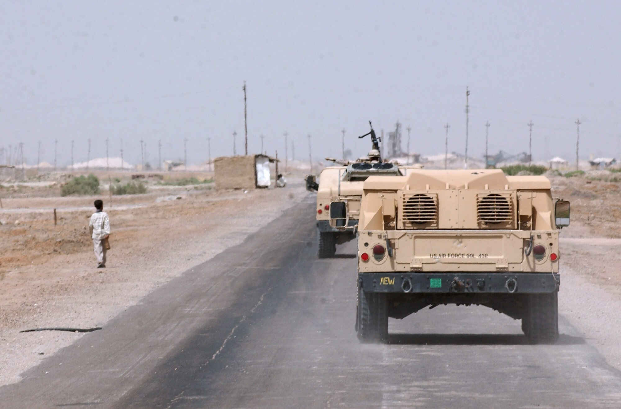 IRAQ -- Humvees from the 407th Expeditionary Security Forces Squadron at nearby Tallil Air Base patrol in the desert.  The squadron's Airmen provide perimeter security to Tallil, and part of their job is to drive about 210 square miles that surrounds the installation to keep U.S. servicemembers and coalition forces safe.  (U.S. Air Force photo by Master Sgt. Maurice Hessel)