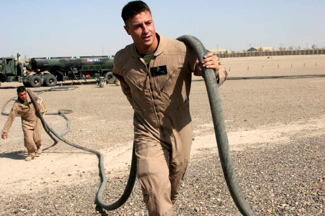 CAMP FALLUJAH, Iraq ? Lance Cpl. Gene Palmer, a bulk fuel specialist with Marine Wing Support Squadron 371 pulls a hose to the fueling point at the forward arming and refueling point.  The Marines can put together the fueling system and be ready to fuel aircraft in 10 minutes.