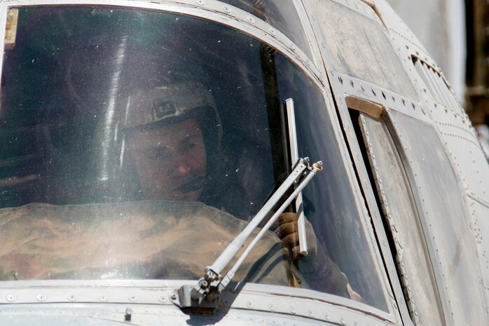 AL QAIM, Iraq ? First Lt. Billy R. Jackson, a CH-46E Sea Knight pilot with Marine Medium Helicopter Squadron 264 and Bonifay, Fla., native, gives the thumbs up as he prepares to start one of the engines on the helicopter June 18.  The ?Black Knights? of HMM-264 have a detachment of Marines and aircraft here conducting casualty evacuation missions during Operation Spear.