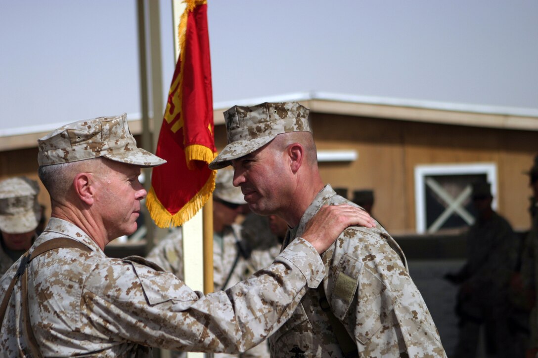 CAMP TAQADDUM, Iraq –Lieutenant Gen. James F. Amos, commanding general II Marine Expeditionary Force, congratulates Brig. Gen. John E. Wissler after a change of command ceremony.  Wissler, a Brroklyn Park, Minn., native, assumed command of 2d Force Service Support Group June 19, 2005.