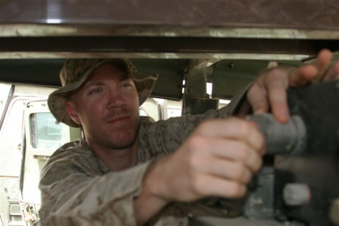 AL TAQADDUM, Iraq ? Lance Cpl. Zac Crum, a radio repair technician with Marine Wing Communications Squadron 38 and Rialto, Calif., native, checks a radio inside a Humvee here June 20. The maintenance platoon is responsible for repairing all communications equipment that may fail during daily operation.