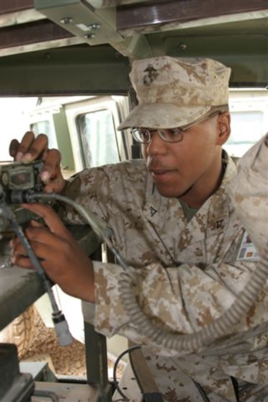 AL TAQADDUM, Iraq - Lance Cpl. Christopher Hickman, a radio repair technician with Marine Wing Communications Squadron 38 checks a field radio for proper operation after repairing it here June 20. The communication squadron?s maintenance platoon has more than 25 Marines who are dedicated to keeping all communications here reliable for use at anytime.