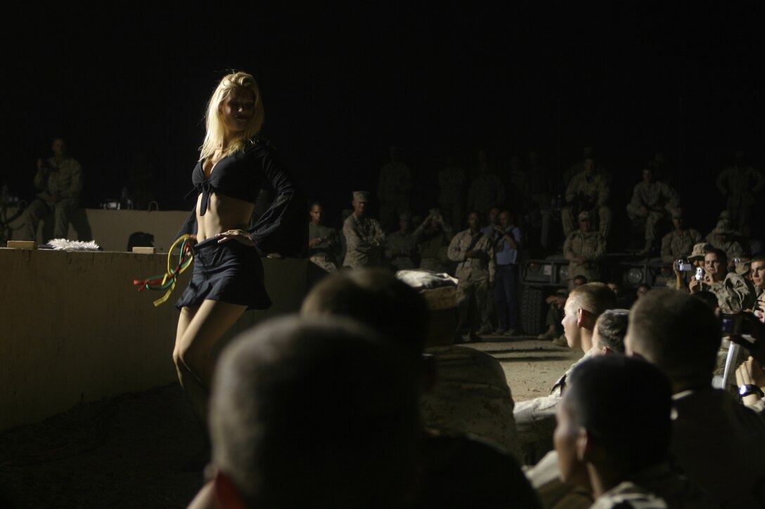 CAMP TAQADDUM, Iraq – “Rachael the Magician”, an Arizona Cardinals cheerleader, performs magic tricks for the servicemembers stationed here June 20 during a performance including dance routines, singing and crowd-participation activities. The cheerleaders entertained hundreds of servicemembers, mostly Marines and Sailors from II Marine Expeditionary Force units, as part of a Morale, Welfare and Recreation-sponsored tour of Iraq showing support for those deployed in support of Operation Iraqi Freedom. (Photo by Cpl. John E. Lawson Jr.)
