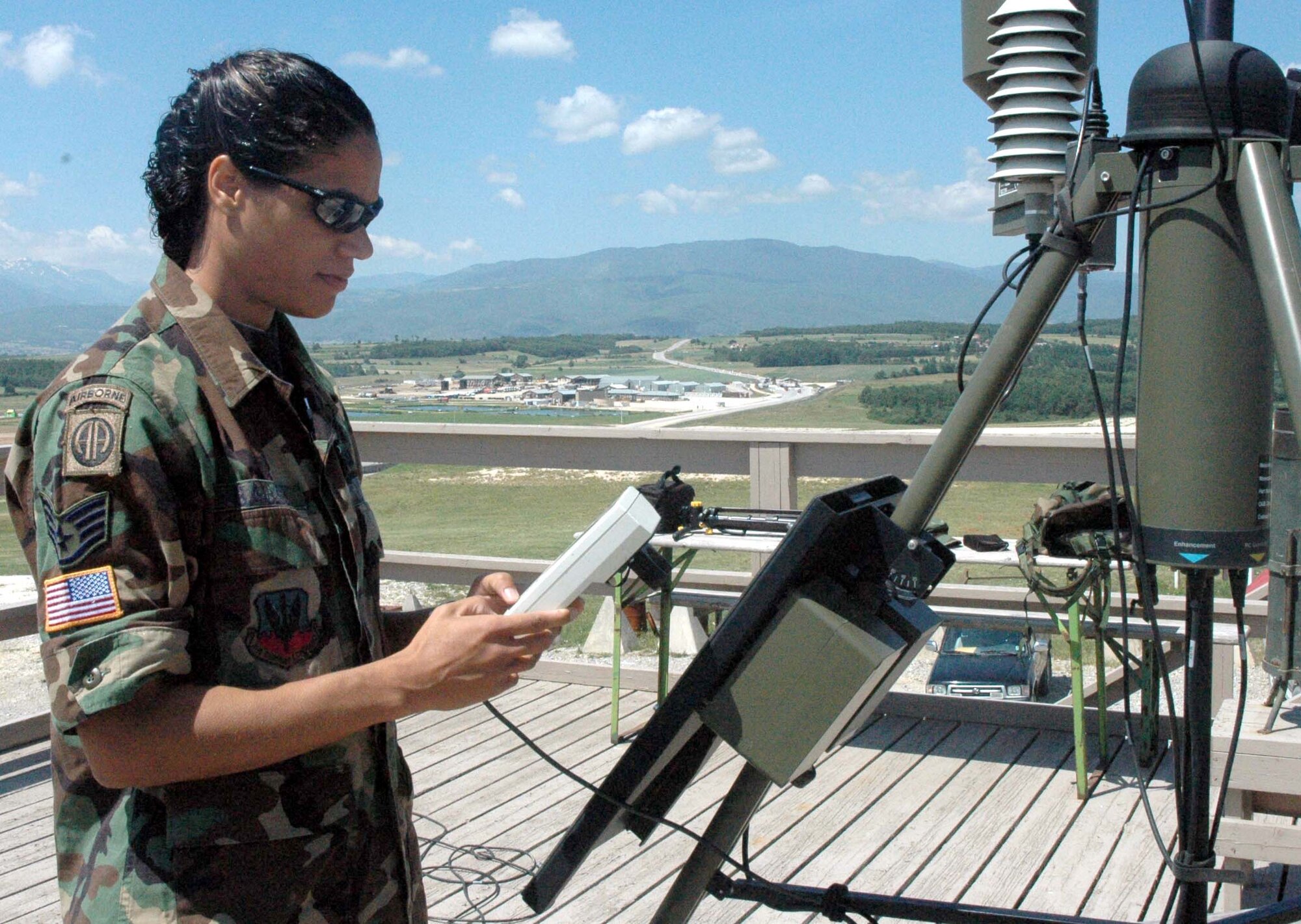 PRISTINA, Serbia and Montenegro -- Staff Sgt. Patricia Ballou reads weather data from tactical weather equipment that aids in remote weather forecasting observations here.  Sergeant Ballou is a weather forecaster deployed to Camp Bondsteel in Kosovo supporting Operation Joint Guardian.  She is deployed from the California Air National Guard's 195th Weather Flight.  (U.S. Air Force photo by Staff Sgt. Carla Williams)