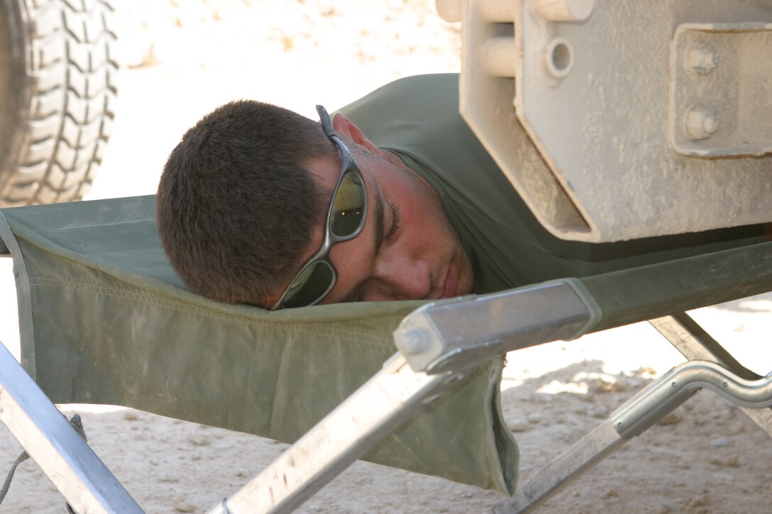 AL ASAD, Iraq (June 23, 2005) - Lance Cpl. Grant M. Saunders, a bulk fuel specialist stationed at Marine Corps Air Station Cherry Point, N.C., who is augmented to Military Police Detachment, Combat Logistics Battalion 2, 2d Force Service Support Group (Forward), takes a quick nap after a Brikwal Patrol. During the patrol the Burlington, N.C., native, and the other Marines with 5th Squad, search Alternate Supply Route Tin for possible mines or improvised explosive devices prior to the convoy traveling the road.