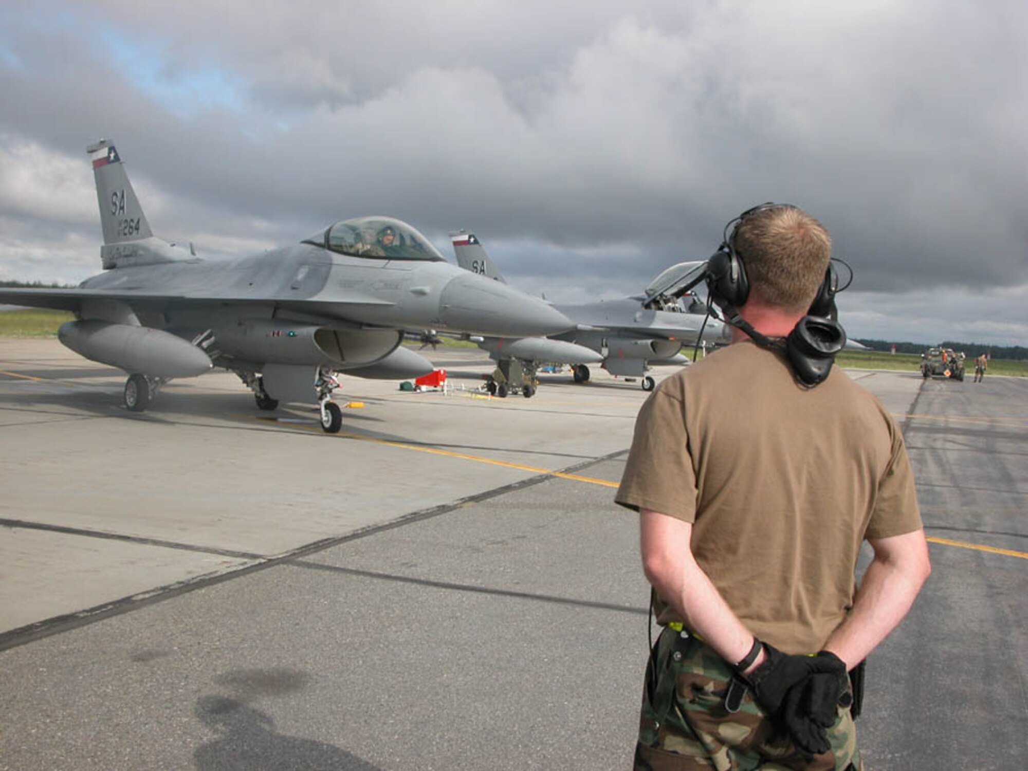 EIELSON AIR FORCE BASE, Alaska -- A crew chief with the Texas Air National Guard's 149th Fighter Wing waits patiently on the flightline here to send off a an F-16 Fighting Falcon on a morning mission during Cooperative Cope Thunder.  The wing is among several Air Force units participating in the exercise.  Other countries with participating units include Japan, Germany, Singapore, Australia, Sri Lanka, Mongolia, Thailand, Bangladesh, South Korea and the United Kingdom.  (U.S. Air Force photo by Master Sgt. Ann Bennett)