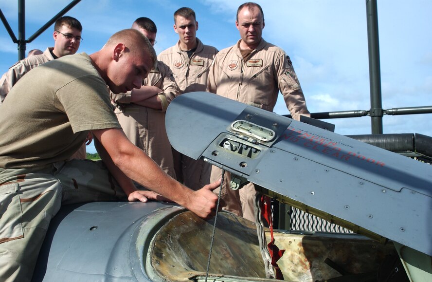 OPERATION ENDURING FREEDOM - Airman 1st Class John Harris shows an aircrew how to load a drag chute on a B-52 Stratofortress bomber at a forward-deployed location.  Aircraft servicing training is conducted periodically for aircrews by maintainers.  The crews require the ground training in the event they land without maintenance support and have to service the aircraft themselves.  Airman Harris is a crew chief deployed to the 40th Expeditionary Maintenance Squadron from Minot Air Force Base, N.D.  (U.S. Air Force photo by Master Sgt. Rich Romero)