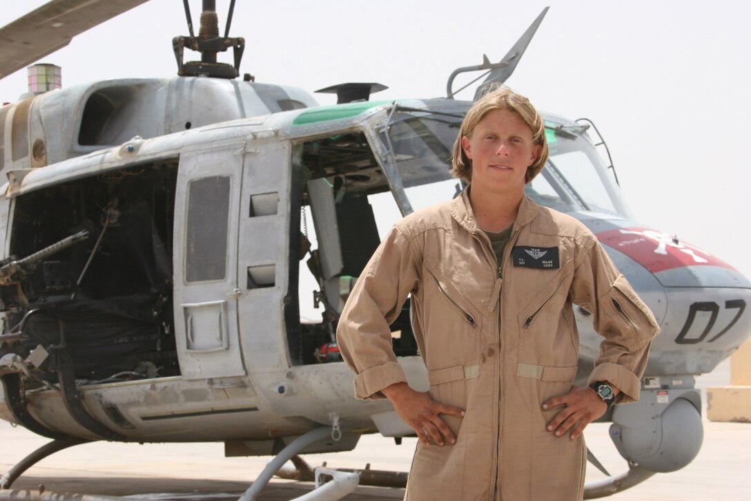AL TAQADDUM, Iraq ? Sergeant Valerie Belue, a crew chief with Marine Light/Attack Squadron 775 poses in front of a UH-1N Huey here. Belue enlisted in the Marine Corps to work and fly on UH-1N Hueys.