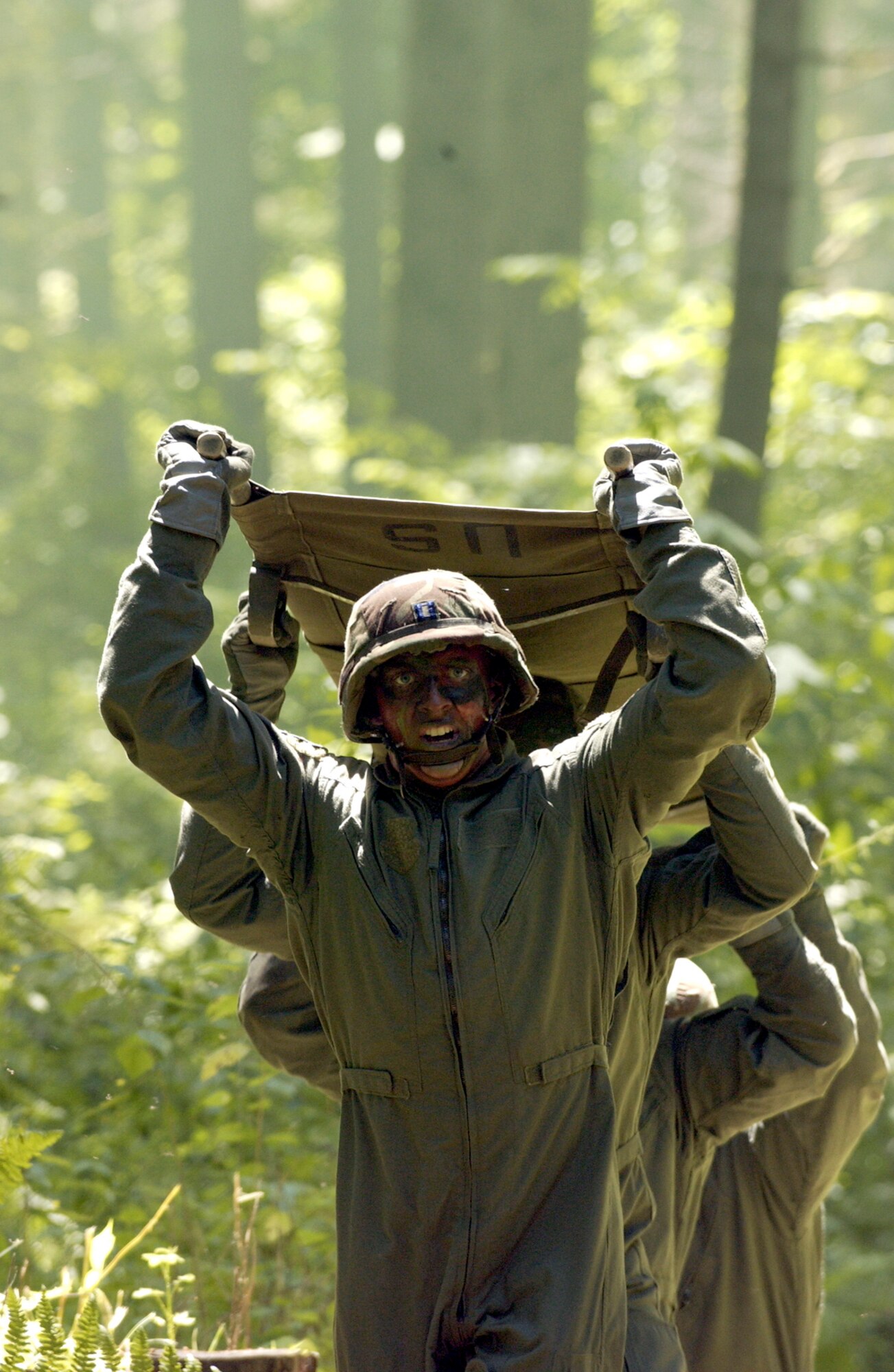 FORT LEWIS, Wash. -- Airmen perform a high litter carry June 20 here during the Rodeo 2005 aeromedical obstacle course. They are assigned to the 86th Aeromedical Evacuation Squadron from Ramstein Air Base, Germany.  (U.S. Air Force photo by Tech. Sgt. Howard Wilson)