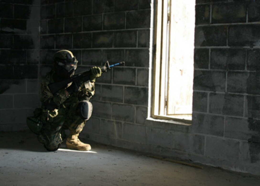 A U.S. Marine watches out a window as he provides security during the Heloborne Raid Course at Camp Lejeune, N.C., on May 11, 2005. Marines from the Battalion Landing Team of the 22nd Marine Expeditionary Unit are training for an upcoming deployment. 