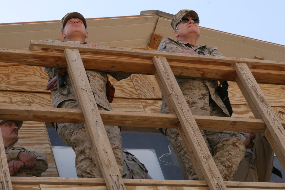 Brig. Gen. Payne and Brig. Gen Kessler discuss possible improvements for supply transportation throughout Al Anbar Province as they stand in a command post overlooking the Al Taqaddum's flight line.