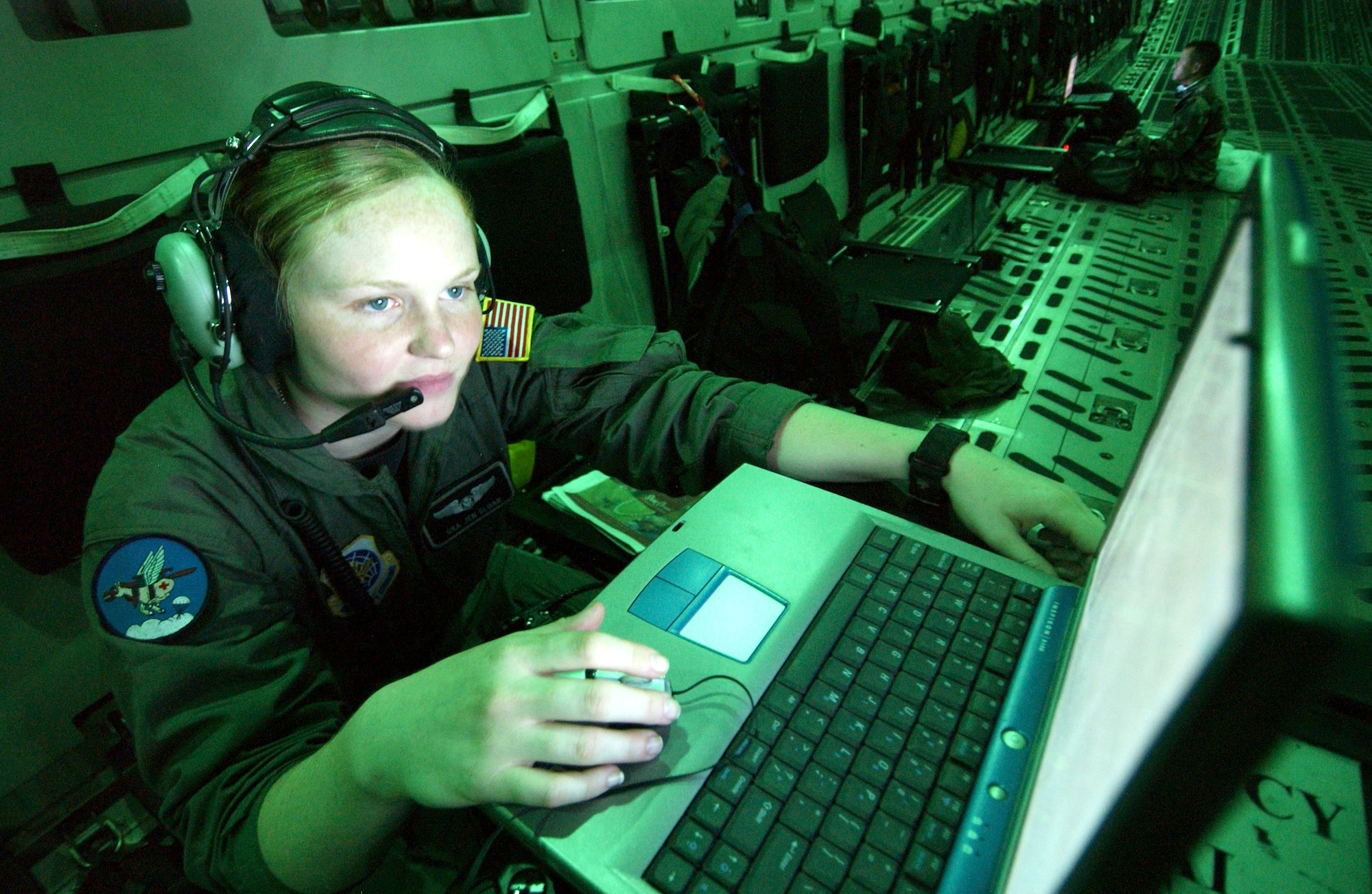 OVER AUSTRALIA -- Senior Airman Jennifer Sloan works on a mission trip report onboard a C-17 Globemaster III on June 19 following an airdrop supporting Talisman Saber 2005.  Airman Sloan is a loadmaster from the 8th Airlift Squadron out of McChord Air Force Base, Wash. (U.S. Air Force photo by Tech. Sgt. Rick Sforza)