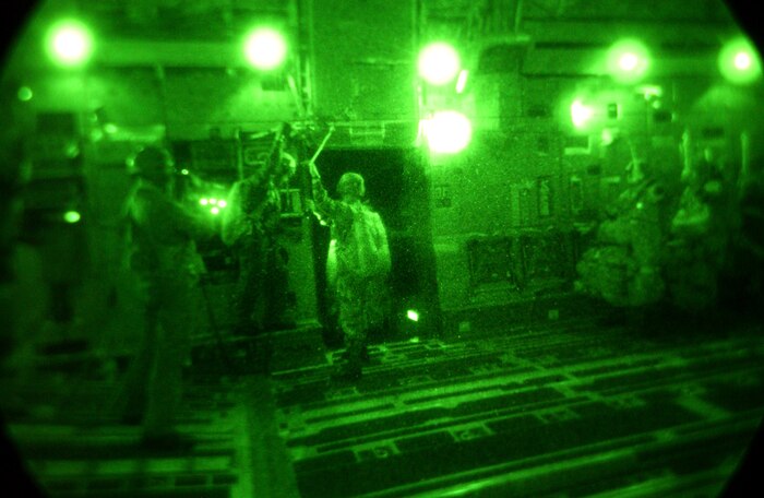OVER AUSTRALIA -- Army paratroopers prepare for a night airdrop from a C-17 Globemaster III on June 17 over Rockhampton, Australia, as part of the Talisman Saber 2005.  Six C-17s from McChord Air Force Base, Wash., and Charleston AFB, S.C., participated in the airdrop as part of the international military exercise designed to improve combat readiness. (U.S. Air Force photo by Tech. Sgt. Rick Sforza)