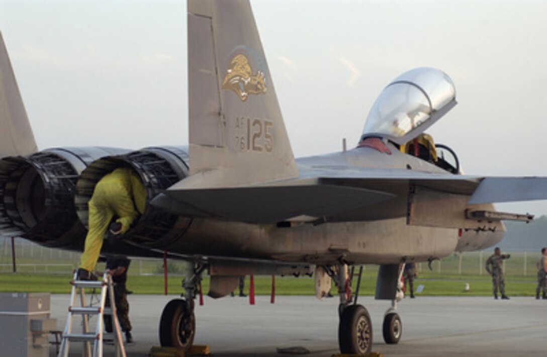 Air National Guard Tech. Sgt. Jose Lopez crawls into the exhaust of an F-15 Eagle fighter to inspect the engine at the Florida Air National Guard's 125th Fighter Wing, Jacksonville International Airport, Fla., on June 17, 2005. Lopez is a nondestructive inspection craftsman with the 125th Maintenance Squadron. 
