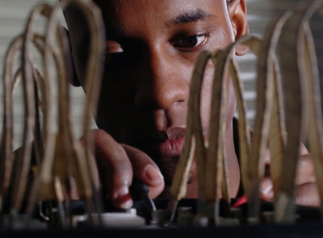 Air Force Airman 1st Class Chad Bowen visually inspects C-17 Globemaster III aircraft instrumentation and navigation systems batteries for corrosion at the 374th Maintenance Squadron Accessories Flight, Yokota Air Base, Japan, on June 23, 2005. Bowen, an electrical and environmental technician, will also ensure that the battery voltage is at the correct level. 