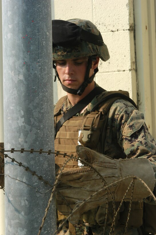 AL ASAD, Iraq ? George Cruz, a sheet metal worker with Boeing?s Iraq Reconstitution Team, bucks a rivet on a bracket for CH-46E Sea Knight?s clam shell door.  A native of Guam, Cruz retired from the U.S. Navy two years ago after 21 years of service.