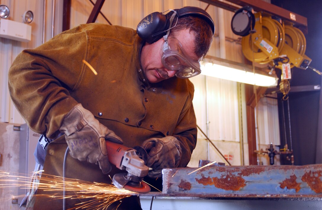 PEASE AIR NATIONAL GUARD BASE, N.H. -- Tech. Sgt. David LaPlante repairs a pivot point on a dump truck tailgate here June 22.  He is a mobile heavy equipment mechanic assigned to the 157th Logistics Squadron.  (U.S. Air Force photo by Senior Airman Curtis J. Lenz)                      