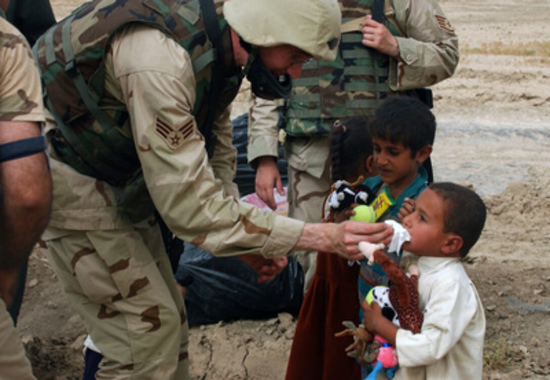 U.S. Air Force Senior Airman Jason Slaghter wipes the nose of a young local Bedouin boy during a humanitarian mission near Ali Base, Iraq, on June 18, 2005. Slaghter and his fellow airmen from the 407th Air Expeditionary Group distributed a large truckload of donated clothing, toys, food and water to six needy families. 