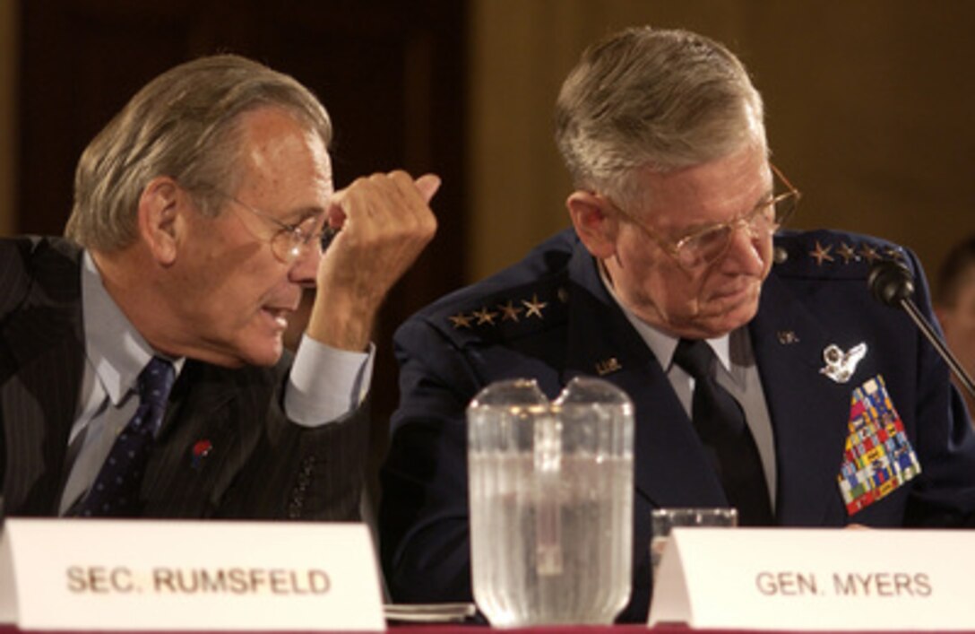 Secretary of Defense Donald H. Rumsfeld (left) talks with Chairman of the Joint Chiefs of Staff Gen. Richard Myers, U.S. Air Force, during a Senate Armed Services Committee hearing on the U.S. military strategy in Iraq on Capitol Hill in Washington, D.C., on June 23, 2005. U.S. Central Command Commander Gen. John Abizaid, U.S. Army, and Commanding General of Multi- National Forces in Iraq Gen. George Casey Jr., U.S. Army, joined Rumsfeld and Myers in testifying before the committee. 