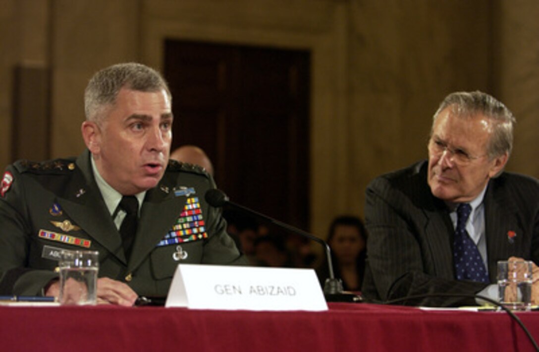 U.S. Central Command Commander Gen. John Abizaid (left), U.S. Army, testifies before the Senate Armed Services Committee on the progress of Iraqi security forces during a hearing on Capitol Hill in Washington, D.C., on June 23, 2005. Abizaid accompanied Secretary of Defense Donald Rumsfeld (right), Chairman of the Joint Chiefs of Staff Gen. Richard Myers, U.S. Air Force, and Commanding General of Multi-National Forces in Iraq Gen. George Casey Jr., U.S. Army, joined in testifying before the committee. 
