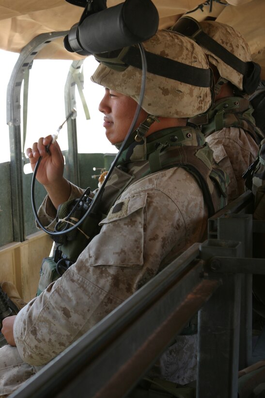 AL ASAD, Iraq (June 26, 2005) - Lance Cpl. Michael V. Juan, Air Delivery Platoon, Transportation Support Company, Combat Logistics Battalion 2, 2d Force Service Support Group (Forward), cools off while riding on a convoy to a drop zone June 26.  The San Francisco native, along with seven other AD Marines traveled to Al Qaim for a supply delivery.