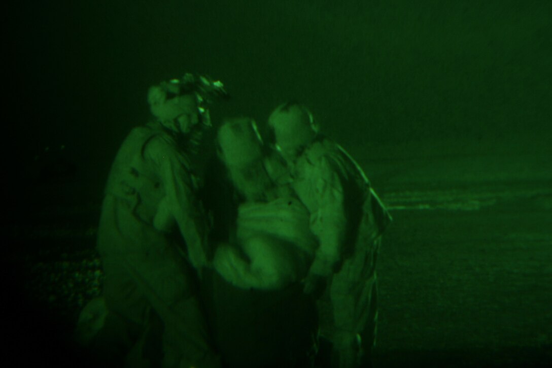 AL ASAD, Iraq (June 26, 2005) - The Marines with Air Delivery Platoon, Transportation Support Company, Combat Logistics Battalion 2, 2d Force Service Support Group (Forward), repack the parachutes used for an early morning supply drop before convoying to the drop site to collect the supplies. Air delivery is used to reduce the number of Marines and vehicles conducting convoy operations needed to deliver supplies to the various Forward Operating Bases throughout the CLB-2 area of operations.