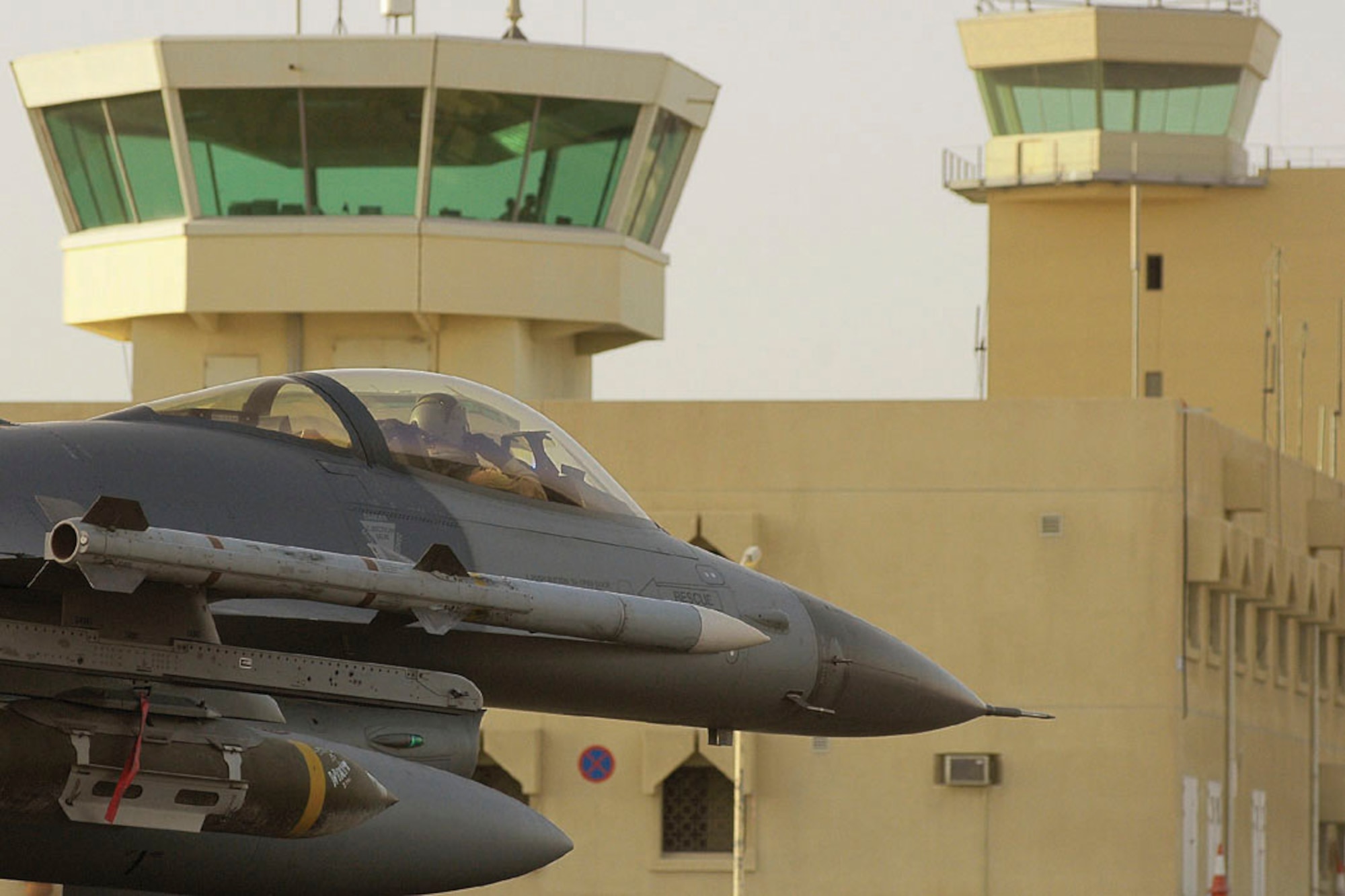 SOUTHWEST ASIA -- Capt. Matt Bertelli taxis to the runway at a forward-deployed location.  He recently dropped a 2,000-pound joint-direct attack munition on two football-field sized bunkers filled with insurgent ordnance and improvised explosive device paraphenalia.  He is an F-16 Fighting Falcon pilot with the 125th Expeditionary Fighter Squadron.  (U.S. Air Force photo by Tech. Sgt. Mark Moore)