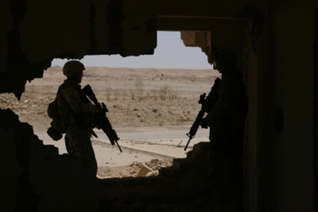 Marines of 1st Battalion, 6th Marines, clear a house as a they look for weapons caches and signs of insurgency during an operation at Tharthar Lake, Iraq, on June 19, 2005. Marines of the 2nd Marine Division and Multi-National Force-West are conducting counter-insurgency operations with Iraqi Security Forces to isolate and neutralize anti-Iraqi Forces in the Tharthar Lake area. 