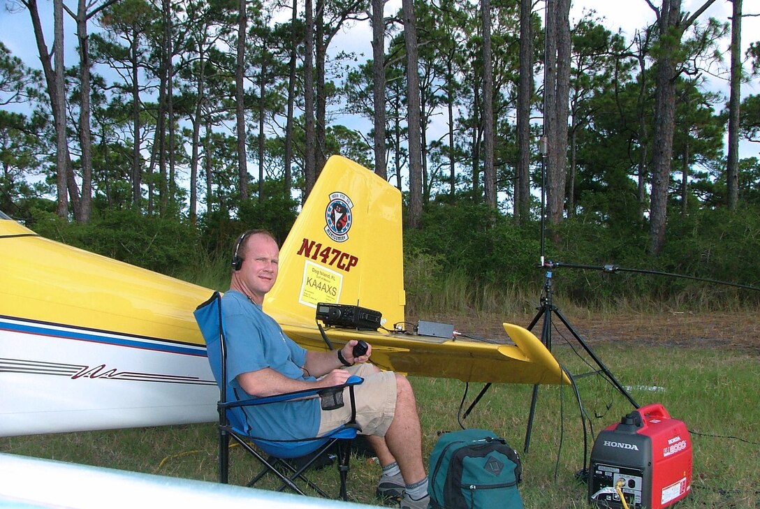 DOG ISLAND, Fla. -- Lt. Col. Edward Linch attempts to contact another amateur radio operator during Field Day 2005.  The nationwide event is held by the American Radio Relay League to link amateur stations with federal, state and local disaster relief agencies.  Colonel Linch flew his private plane here -- an island with no permanent residents or formal airfield -- establishing a link to 36 other operators during extremely poor atmospheric conditions.  He is the wing plans chief of the 505th Command and Control Wing at nearby Hurlburt Field.  (U.S. Air Force photo)