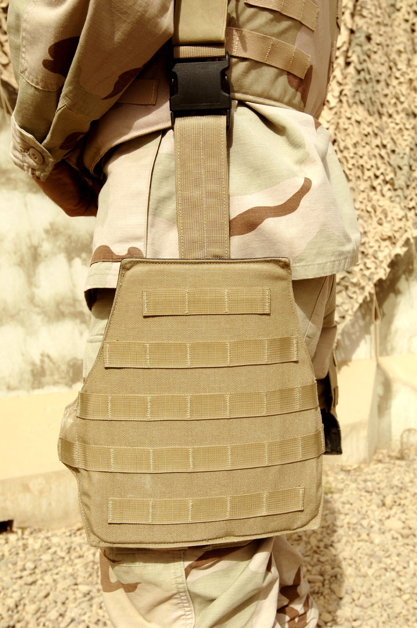 BALAD AIR BASE, Iraq -- Tech. Sgt. Gerald Lowry displays the leg protector that is part of the new "Level 4" body armor being tested here by Air Force Research Laboratory officials at Wright-Patterson Air Force Base, Ohio.  The armor includes a new form of ceramic plate that can withstand more bullet strikes than current plates, as well as bicep and rib protectors.  Sergeant Lowry is a 332nd Expeditionary Communications Squadron network administrator.  (U.S. Air Force photo by Senior Airman Jason Robertson)