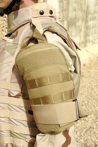 BALAD AIR BASE, Iraq -- Tech. Sgt. Gerald Lowry displays the bicep protector that is part of the new "Level 4" body armor being tested here by Air Force Research Laboratory officials at Wright-Patterson Air Force Base, Ohio.  The armor includes a new form of ceramic plate that can withstand more bullet strikes than current plates, as well as leg and rib protectors.  Sergeant Lowry is a 332nd Expeditionary Communications Squadron network administrator.  (U.S. Air Force photo by Senior Airman Jason Robertson)