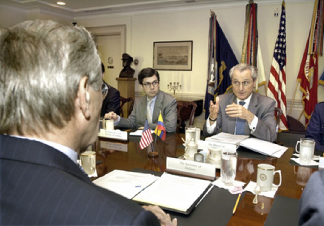 Colombian Minister of Defense Jorge Uribe (right) meets with Secretary of Defense Donald H. Rumsfeld (foreground) in the Pentagon on June 27, 2005. Uribe and Rumsfeld are discussing a wide range of bilateral and regional security issues. Joining Uribe for the talks is Colombia's Ambassador to the United States Luis Alberto Mejia Moreno (center). 