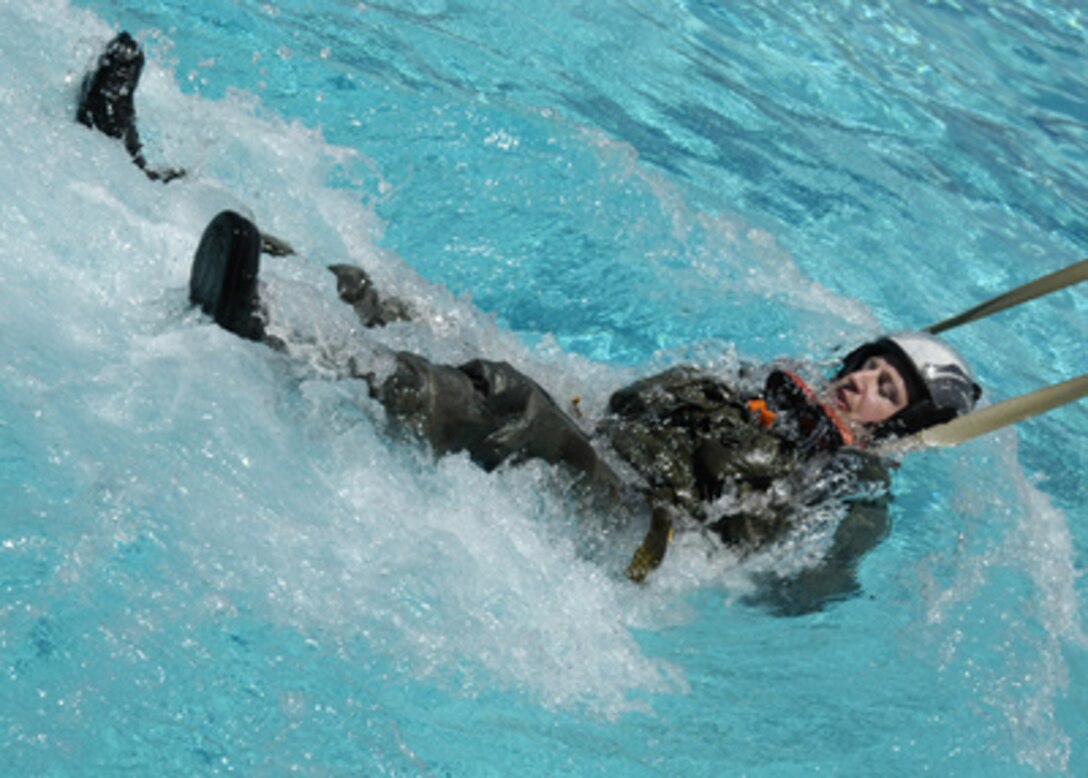 An aircrew student is dragged through a pool at the Aviation Survival Training Center to simulate an ejection seat being pulled by a parachute in water on June 23, 2005. The Training Center at Marine Corps Air Station Miramar, Calif., provides aviation physiology and water survival training for pilots and aircrew. 
