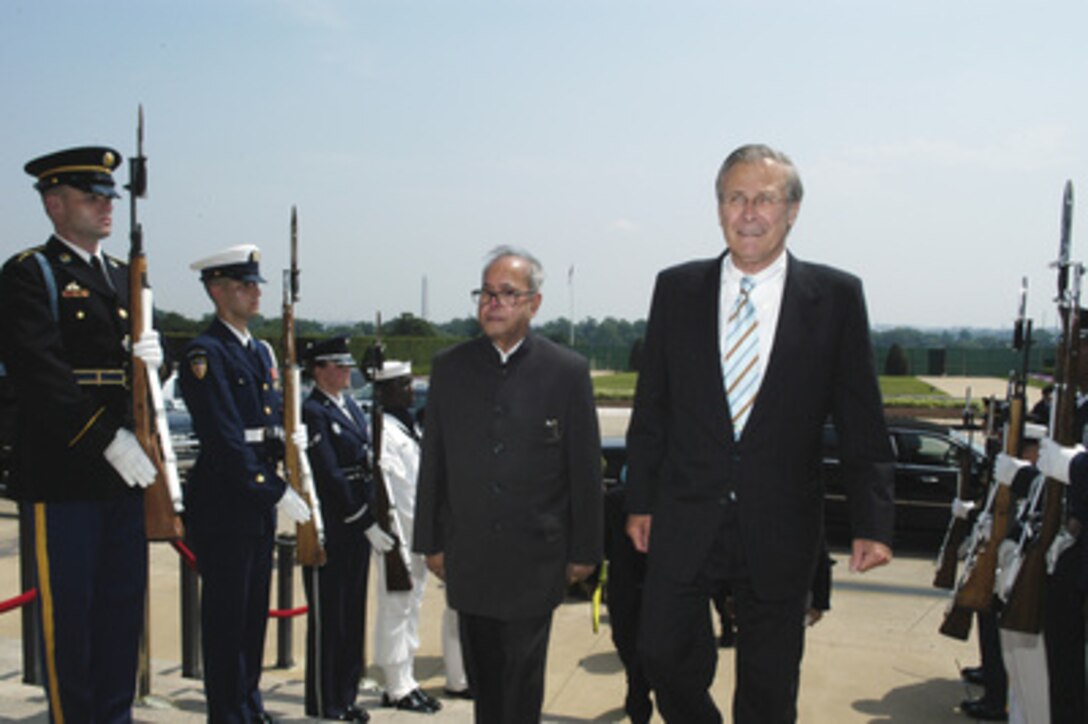 Secretary of Defense Donald H. Rumsfeld (right) escorts India's Minister of Defense Pranab Mukherjee (left) through an honor cordon and into the Pentagon on June 28, 2005. Rumsfeld and Mukherjee will meet to discuss defense issues of mutual interest. 