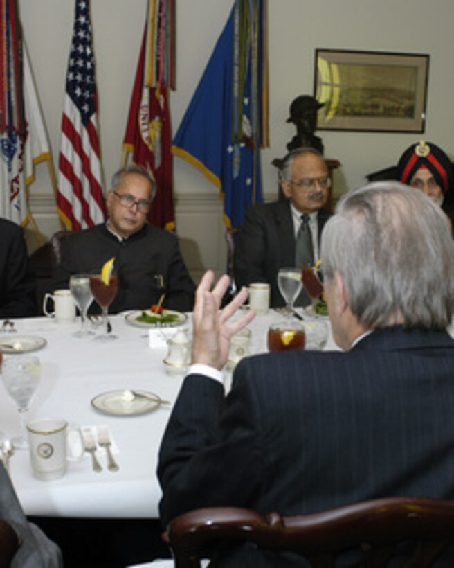 Secretary of Defense Donald H. Rumsfeld (foreground) speaks to India's Minister of Defense Pranab Mukherjee (left) during a working luncheon in the Pentagon on June 28, 2005. Rumsfeld and Mukherjee are meeting to discuss defense issues of mutual interest. Seated with Mukherjee are Defense Secretary Ajai Vikram Singh and Deputy Chief of the Army Staff Lt. Gen. P.P.S. Bhandari. 