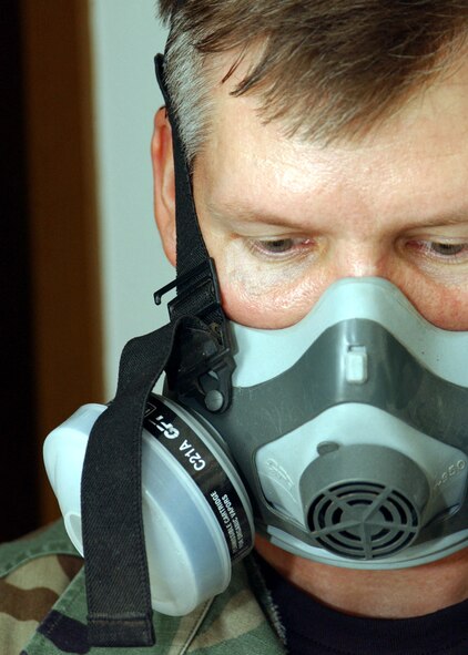 EIELSON AIR FORCE BASE, Alaska -- Tech. Sgt. Richard Hartke uses a respirator while applying pesticide in base housing here June 28.  The 354th Civil Engineer Squadron's pest management section Airmen use biological, mechanical and cultural methods to deter and catch pests around base.  (U.S. Air Force photo by Staff Sgt. Joshua Strang)