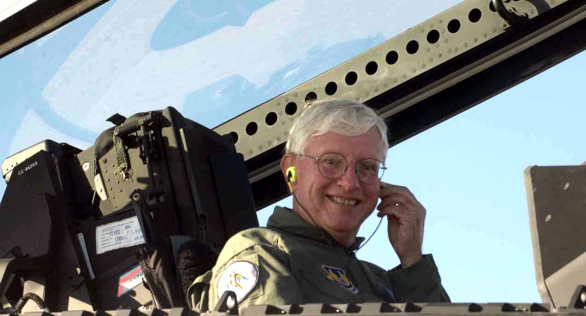 LANGLEY AIR FORCE BASE, Va. -- Hendrick Ruck demonstrates the wear of the attenuating customized communications earpiece system while sitting the cockpit of one of Langley's new F/A-22 Raptors.  Mr. Ruck is director of the Air Force Research Laboratory's research team from Wright-Patterson Air Force Base, Ohio.  (U.S. Air Force photo by Senior Airman DeLicha E. Germany)