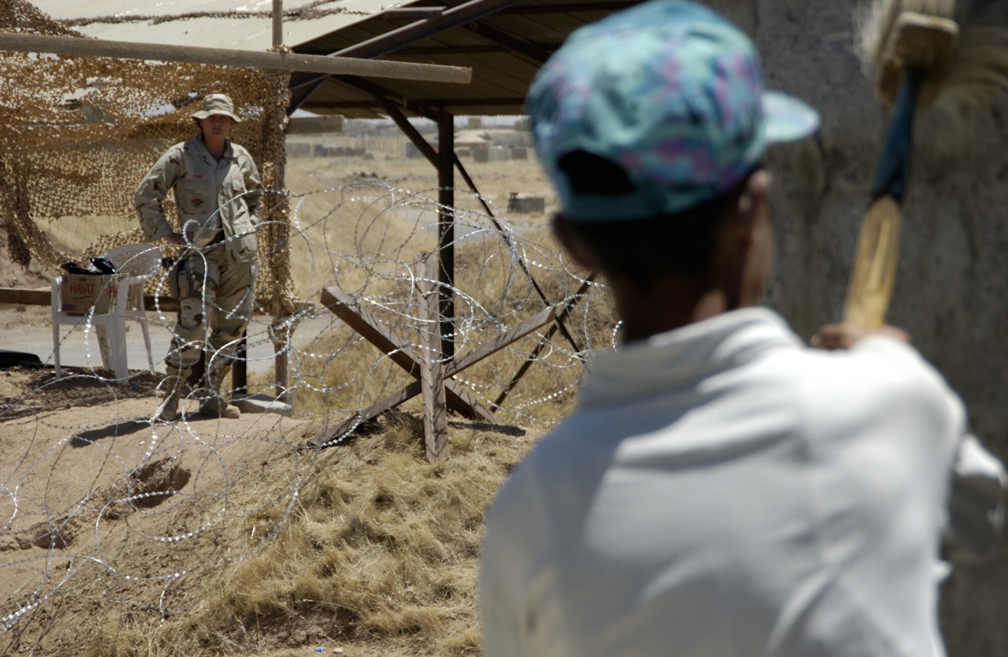 KIRKUK AIR BASE, Iraq -- Airman 1st Class Jennifer Pemp monitors third-country nationals as they construct a building here.  Hundreds of local employees work on the base daily under the watchful eye of escorts.  Airman Pemp is deployed from Mountain Home Air Force Base, Idaho.  (U.S. Air Force photo by Tech. Sgt. Christopher Gish)