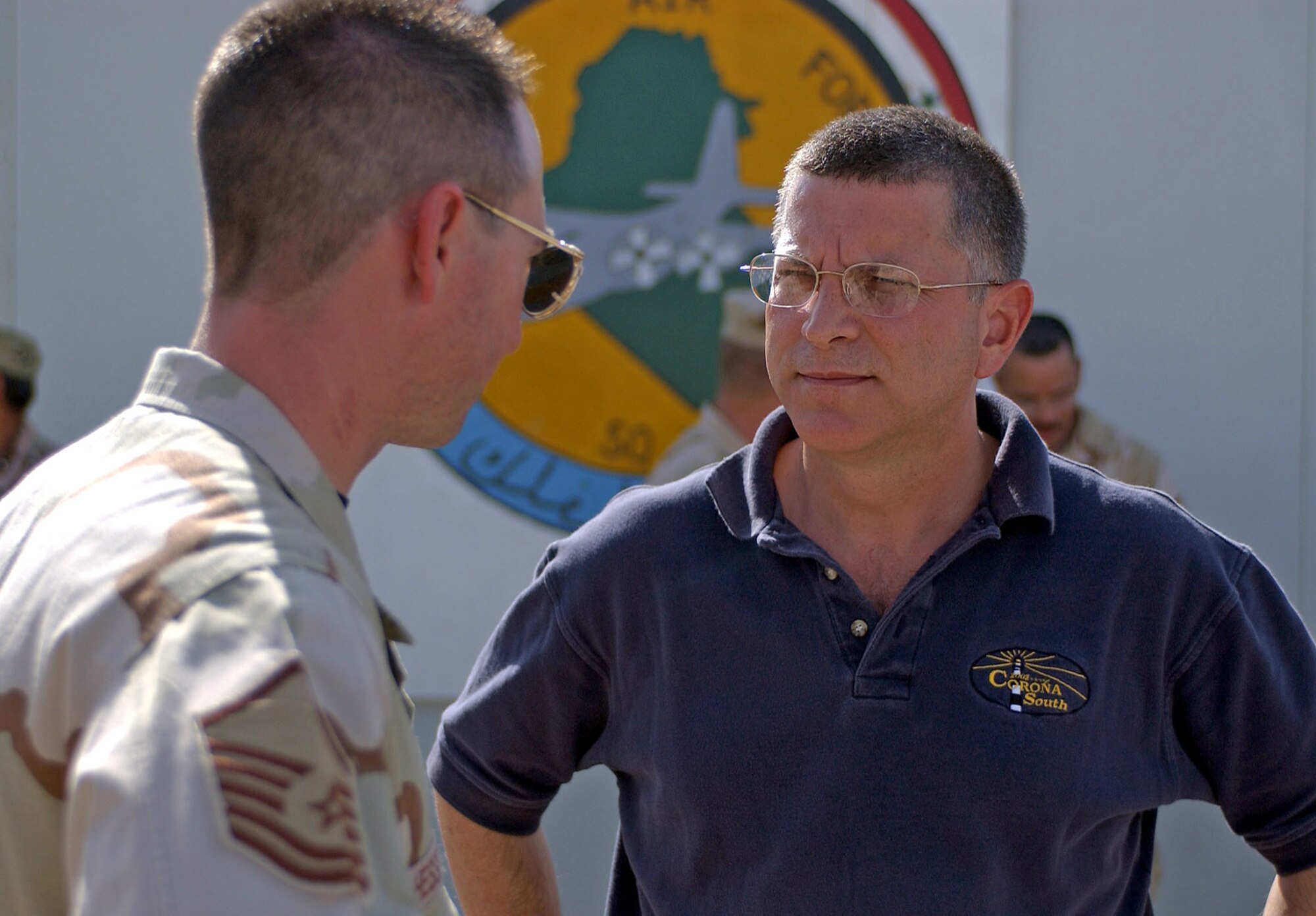 TALLIL AIR BASE, Iraq -- Michael L. Dominguez, acting secretary of the Air Force, speaks with Master Sgt. Lloyd Hesseltine during a visit here June 29.  Mr. Dominguez told Airmen the importance of the U.S. military's mission in Iraq and what the future image of an Air Force warfighter will look like.  Sergeant Hesseltine is assigned to the 777th Expeditionary Aircraft Maintenance Squadron.  (U.S. Air Force photo by Master Sgt. Maurice Hessel)