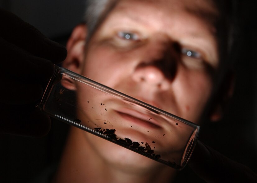 EIELSON AIR FORCE BASE, Alaska -- Tech. Sgt. Richard Hartke inspects a jar of bedbugs here June 28.  The 354th Civil Engineer Squadron’s pest management section Airmen use biological, mechanical and cultural methods to deter and catch pests around base.  (U.S. Air Force photo by Staff Sgt. Joshua Strang)