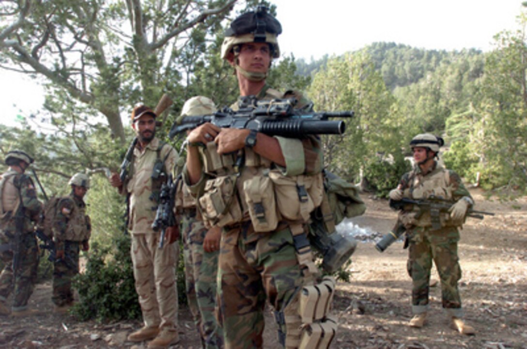 U.S. Army soldiers from Alpha Company, 1st Battalion, 508th Infantry (Airborne), prepare to move out on another mission in Mangritae, Afghanistan, on June 25, 2005. The soldiers are patrolling the area and searching for remaining members of the Taliban. 