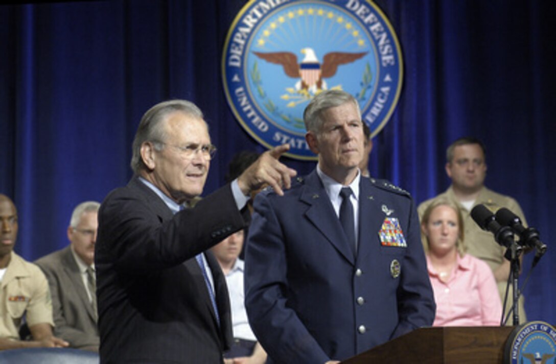 Secretary of Defense Donald H. Rumsfeld (left) calls for a question during Pentagon Town Hall meeting on June 29, 2005. Rumsfeld and Chairman of the Joint Chiefs of Staff Gen. Richard B. Myers, U.S. Air Force, fielded a variety of questions from military and civilian Department of Defense employees. The meeting was televised live to service men and women worldwide on the Pentagon Channel. 