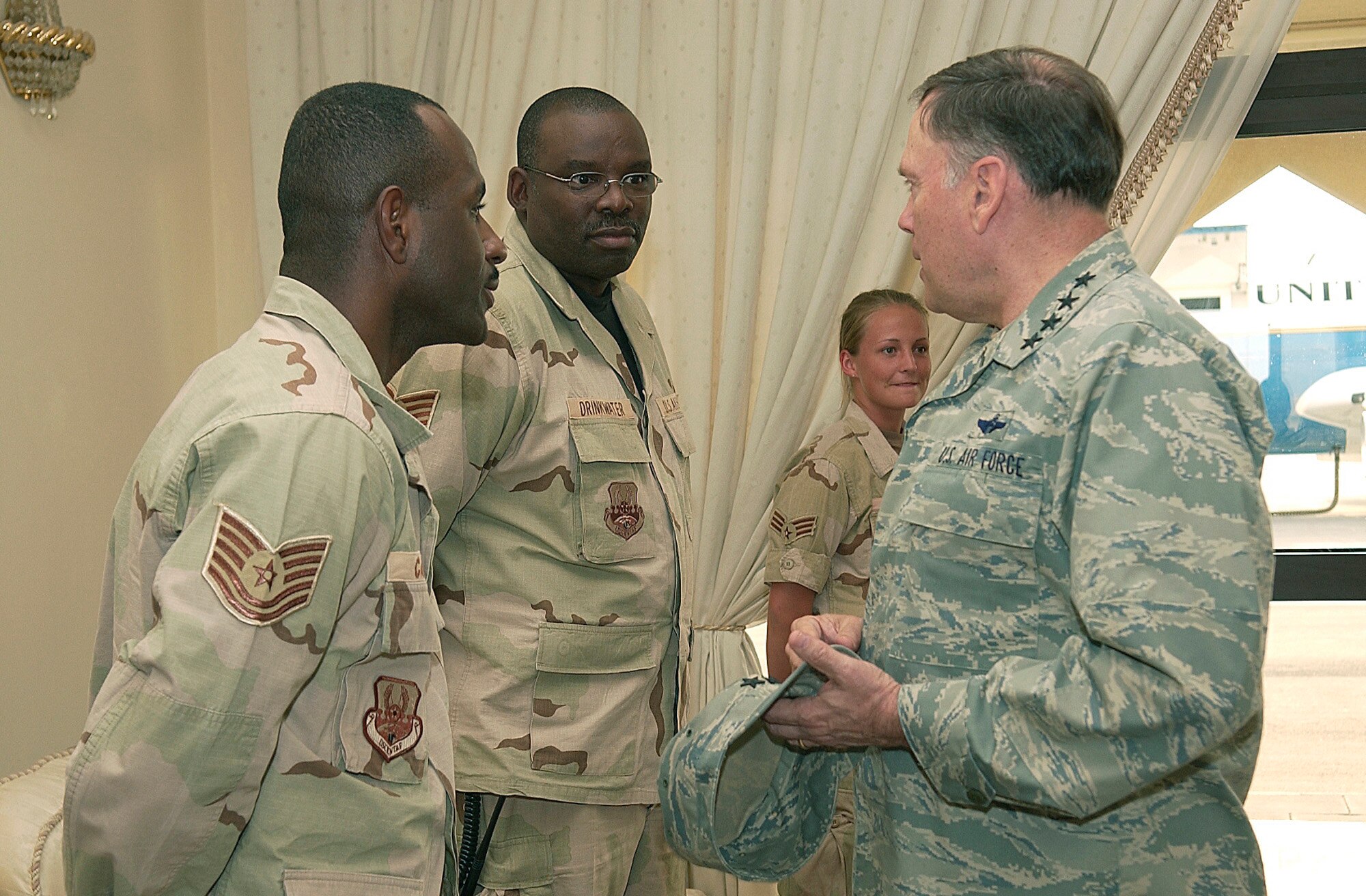 SOUTHWEST ASIA -- Air Force Chief of Staff Gen. John P. Jumper speaks with Tech. Sgts. Kenneth Canada (left) and Ricky Drinkwater and Senior Airman Tiffany Luff at a forward-deployed location here recently.  Sergeants Canada and Drinkwater are deployed from Maxwell Air Force Base, Ala., and Airman Luff is deployed from Robins Air Force Base, Ga.  The reservists are assigned to the 8th Expeditionary Air Mobility Squadron.  (U.S. Air Force photo by Staff Sgt. Colette Bennett)