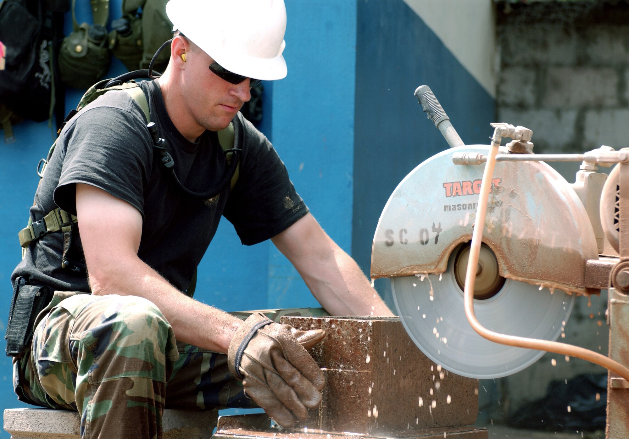 TEPETITAN, El Salvador -- Senior Airman Jake Kurtz uses a masonry saw to cut stone blocks for a clinic-expansion project here for exercise New Horizons.  About 600 Airmen, Soldiers, Sailors and Marines are providing humanitarian assistance to people of El Salvador during the U.S. Southern Command-sponsored readiness training exercise.  Airman Kurtz is assigned to the 28th Civil Engineer Squadron.  (U.S. Air Force photo by Staff Sgt. Karen J. Tomasik)
