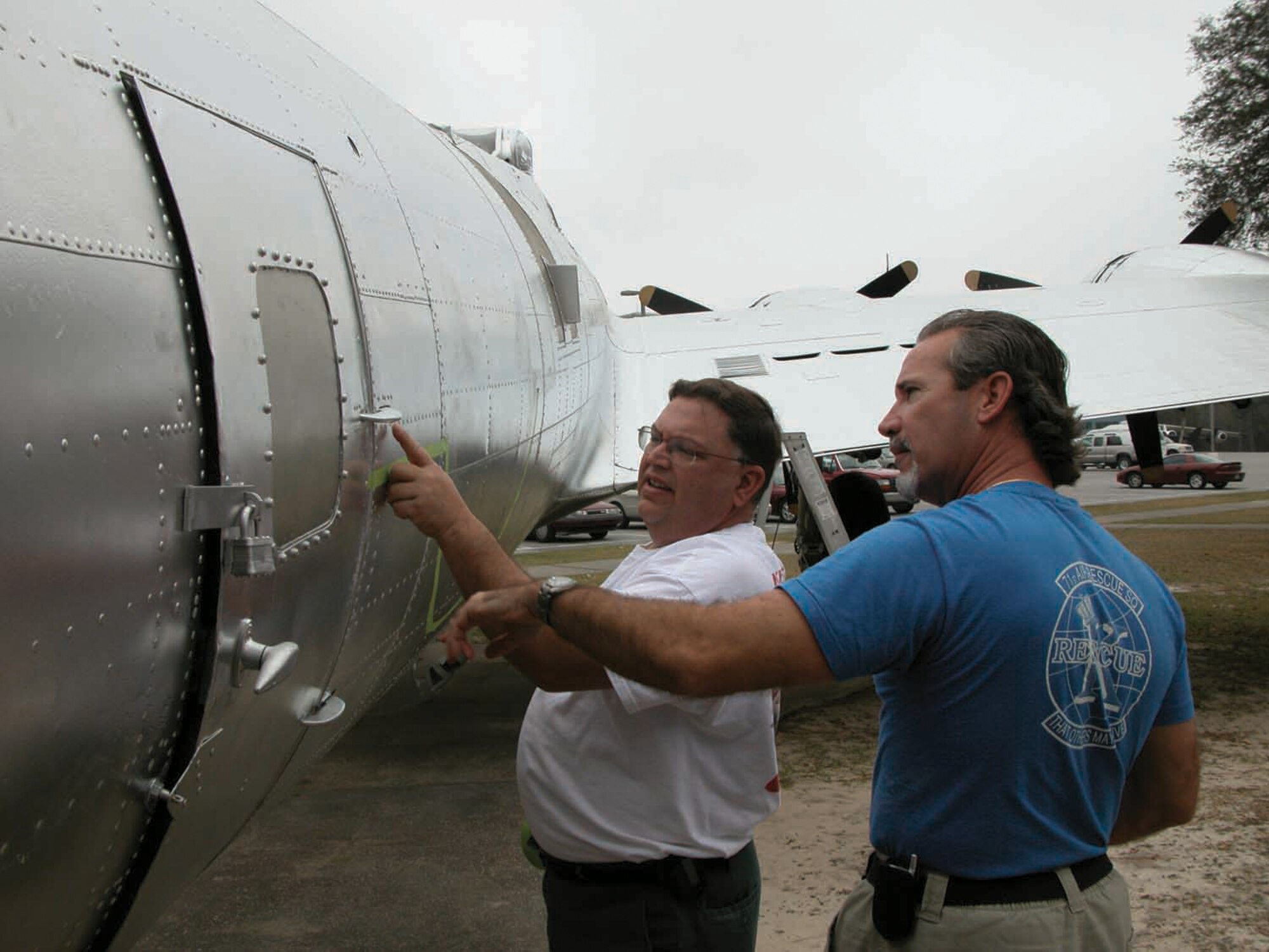 EGLIN AIR FORCE BASE, Fla. -- George Jones and Tim Savoir tape an insignia on a WWII-era B-17G Flying Fortress at the Air Force Armament Museum here.  Officials are looking for volunteers to restore and maintain the aircraft on display at the museum.  (U.S. Air Force photo by Lois Walsh)
