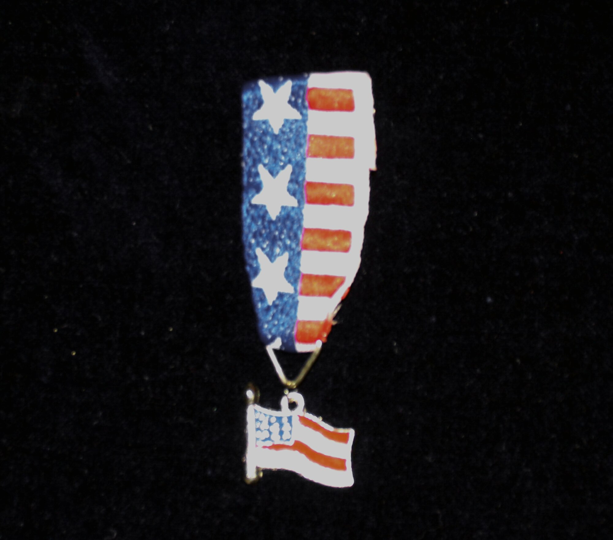HANSCOM AIR FORCE BASE -- The Children's Home Front Hero Medal, which features a replica of the American flag, is presented to Hanscom children of deployed servicemembers.  (U.S. Air Force photo by Tech. Sgt. Eric Grill)