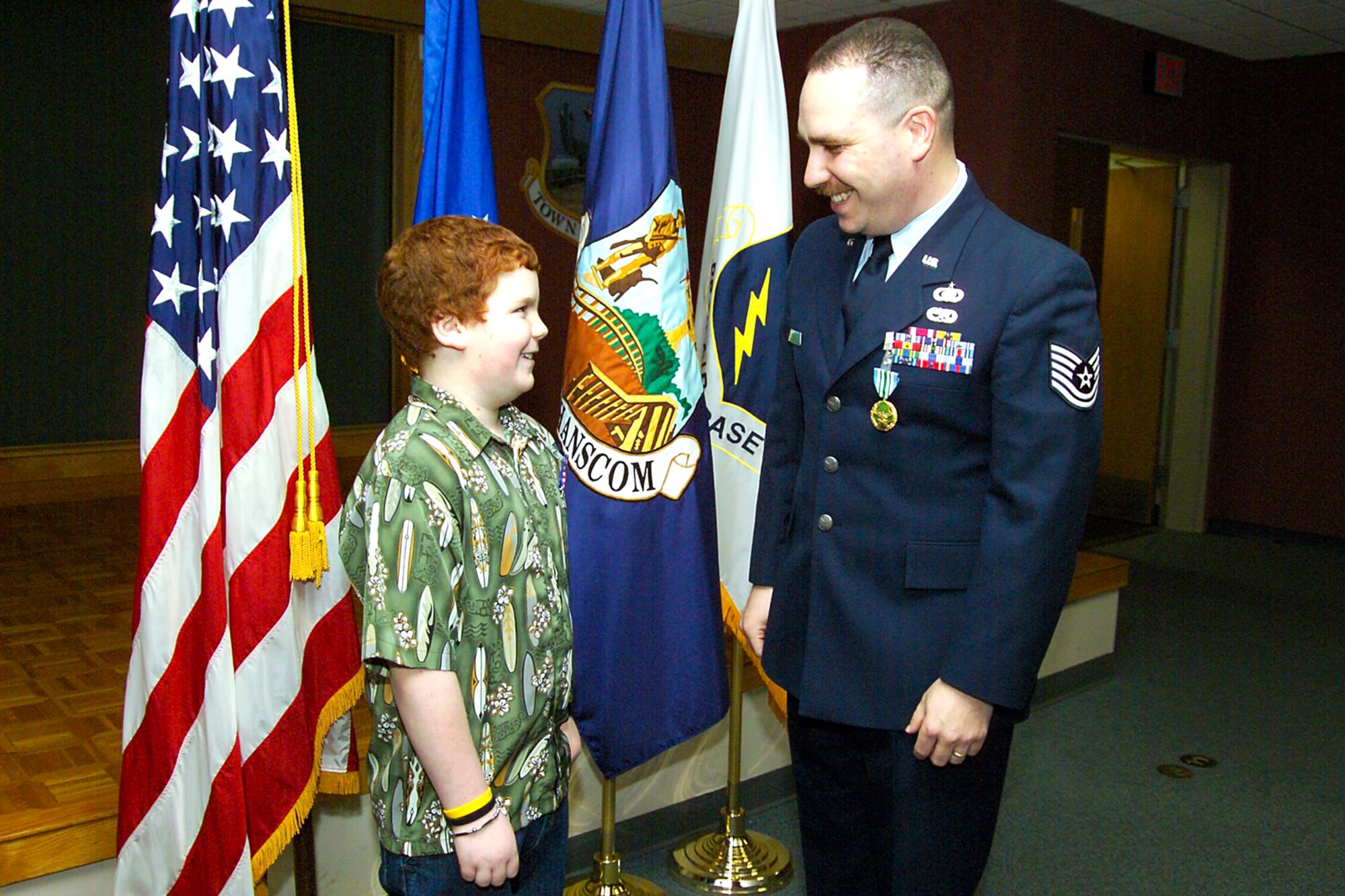 HANSCOM AIR FORCE BASE -- Ten-year-old Ethan Grill beams after receiving his Children's Homefront Heroes Medal from his father, Tech. Sgt. Eric Grill, Feb. 24.  The medal, which features a replica of the American flag, is presented to Hanscom children of deployed servicemembers.  (U.S. Air Force photo by Jan Abate)